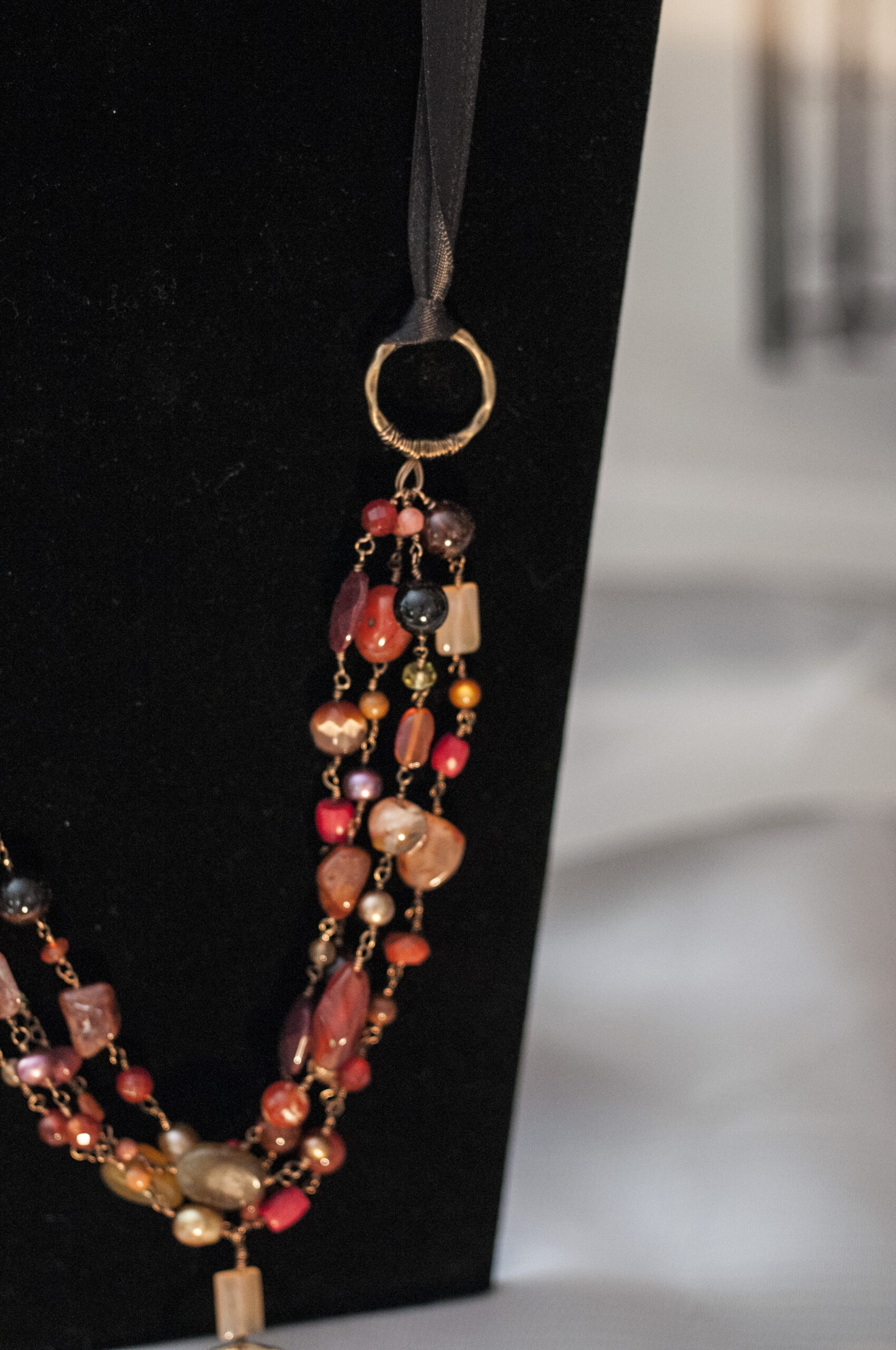 close up of long glass flame necklace