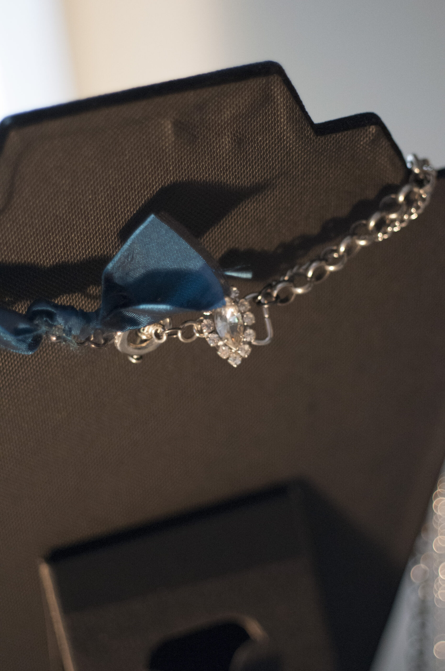 close up of clasp on long blue necklace
