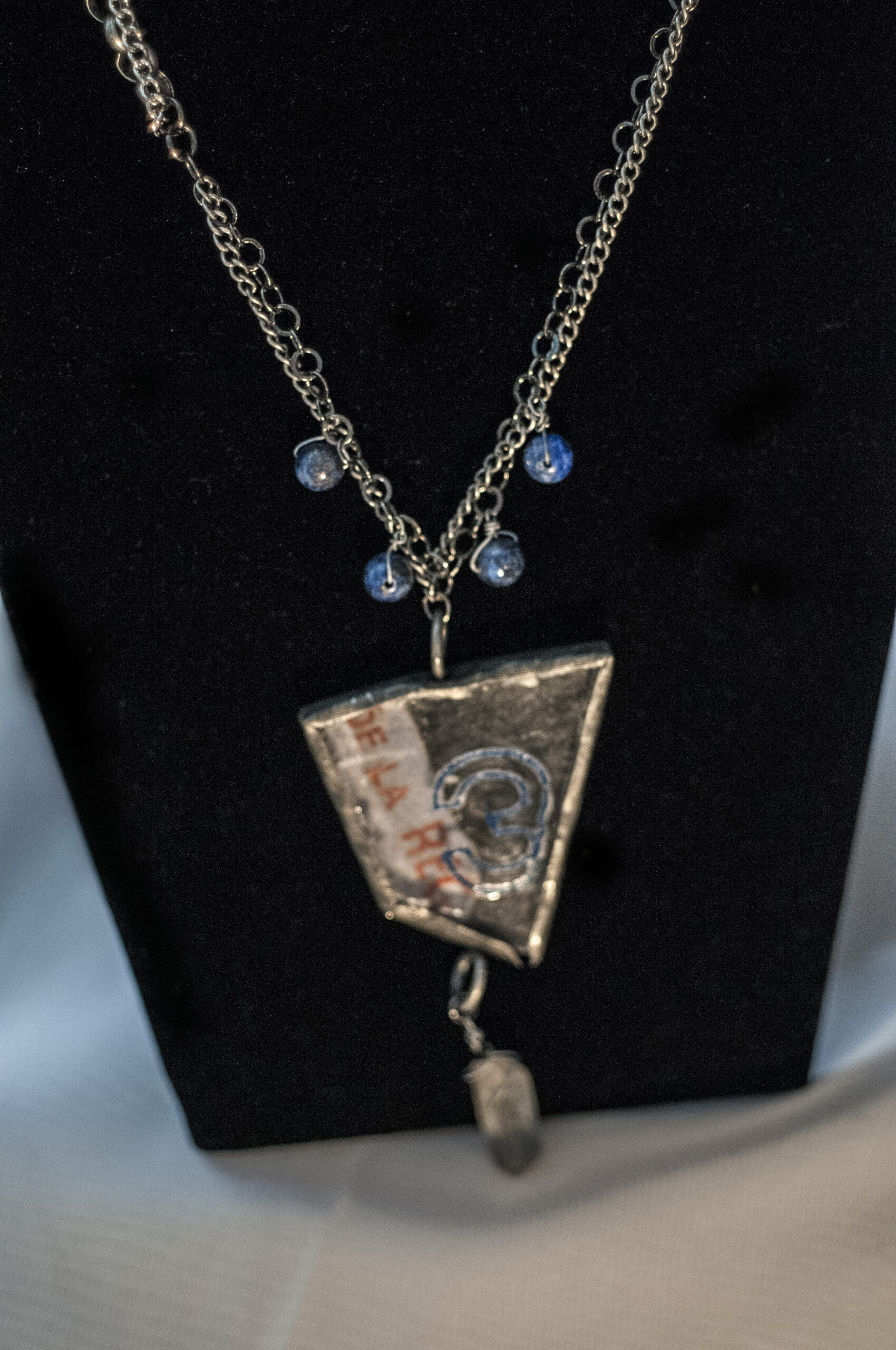 close up of pendant and blue beads